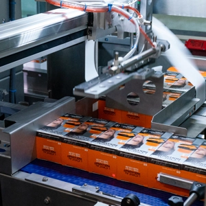 L'oreal products being banded by a fully automatic machine L'oreal products being banded by a fully automatic machine